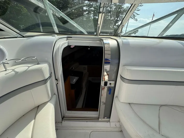  Yacht Photos Pics Interior view of a 2008 Donzi 38 ZSF boat, featuring white seating and cabin entrance.