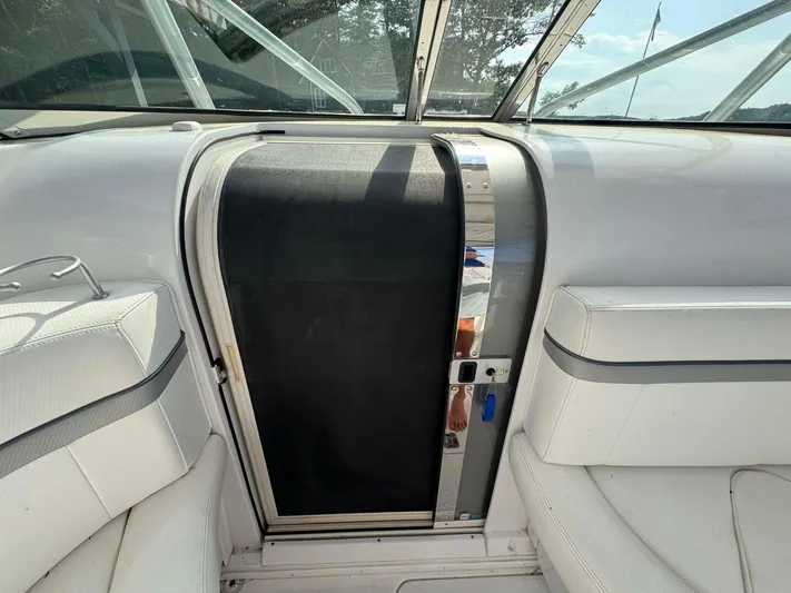  Yacht Photos Pics Interior view of a 2008 Donzi 38 ZSF boat with white seating and a cabin door.