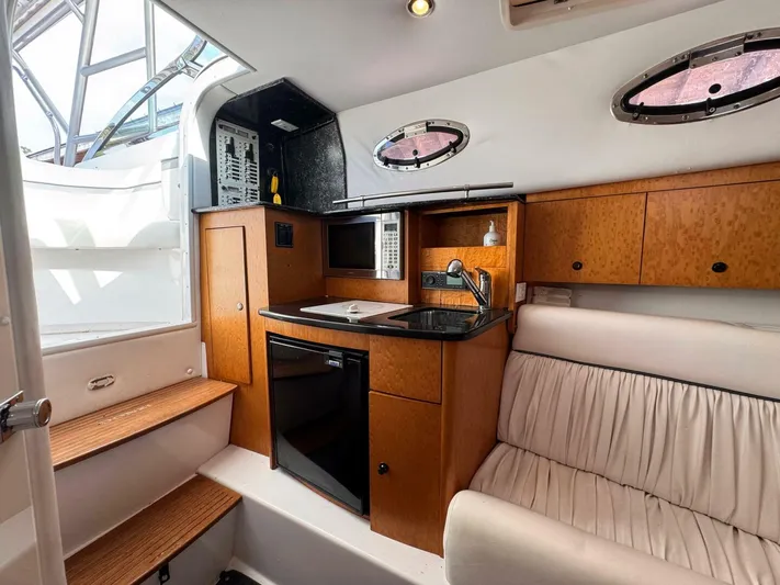  Yacht Photos Pics Interior of 2008 Donzi 38 ZSF boat with kitchenette and seating area.