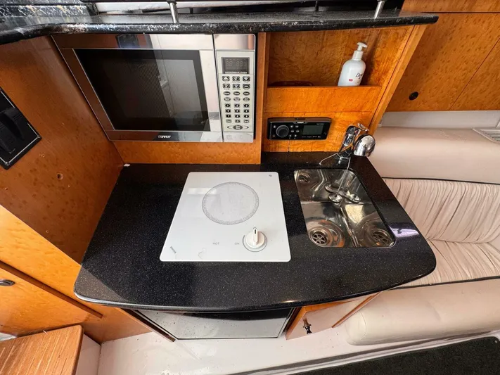  Yacht Photos Pics 2008 Donzi 38 ZSF boat interior kitchen with microwave, sink, and stove.