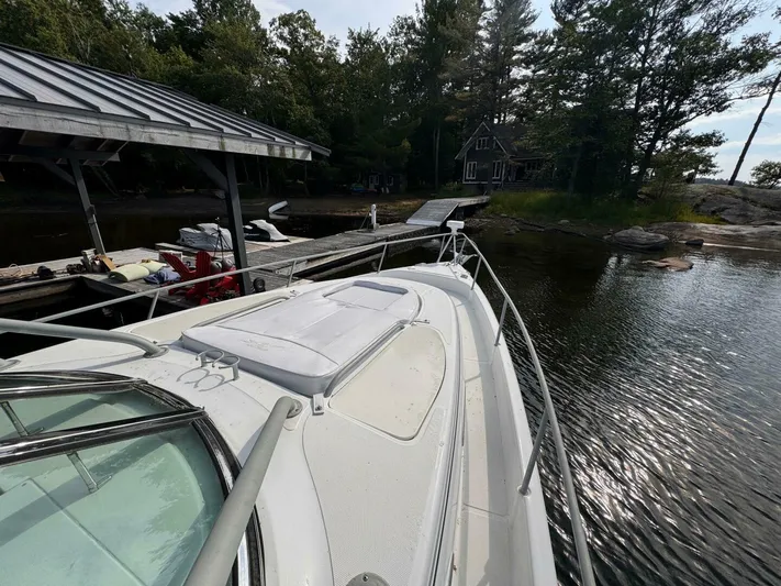  Yacht Photos Pics 2008 Donzi 38 ZSF boat docked near a lakeside cabin with trees.