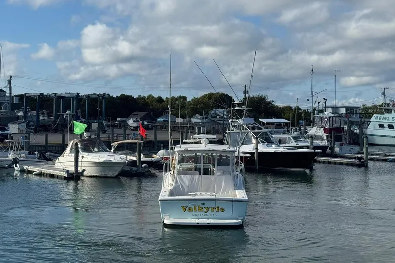 Valkyrie Yacht Photos Pics 2004 Pursuit 3400 Offshore boat named Valkyrie docked in a marina under cloudy skies.