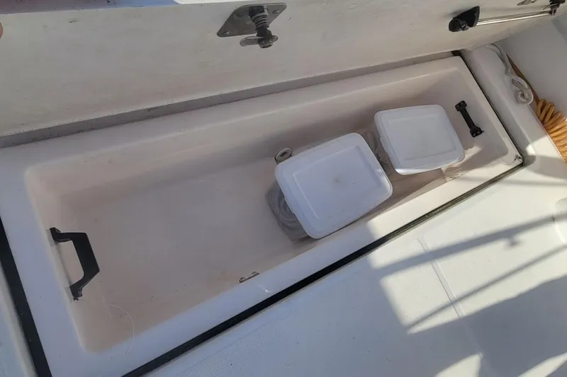 Valkyrie Yacht Photos Pics Storage compartment on a 2004 Pursuit 3400 Offshore boat, featuring two containers.