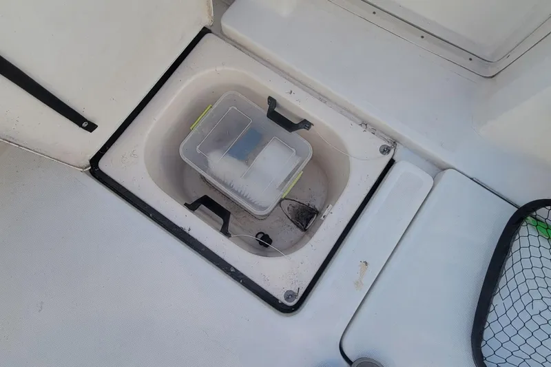 Valkyrie Yacht Photos Pics Storage compartment on 2004 Pursuit 3400 Offshore boat with plastic container inside.