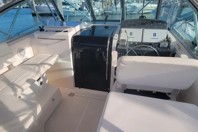 Valkyrie Yacht Photos Pics 2004 Pursuit 3400 Offshore boat interior with helm, seating, and navigation equipment.