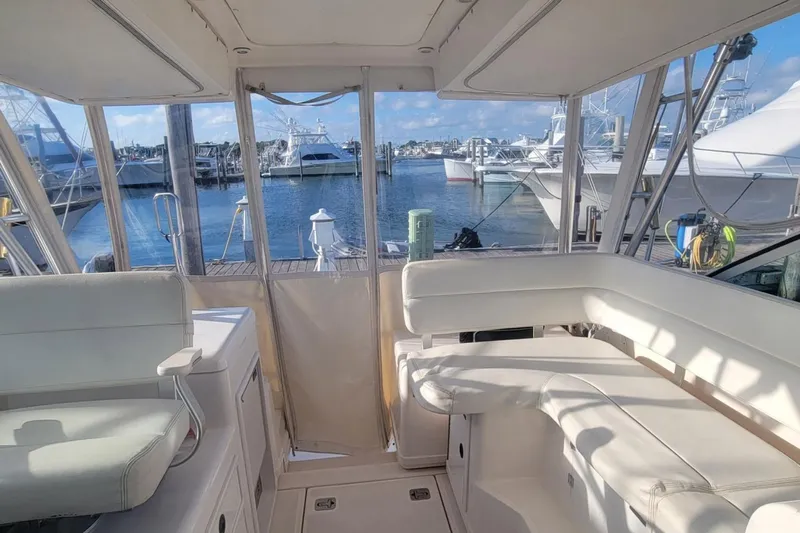 Valkyrie Yacht Photos Pics 2004 Pursuit 3400 Offshore boat interior with white seating, docked at marina.