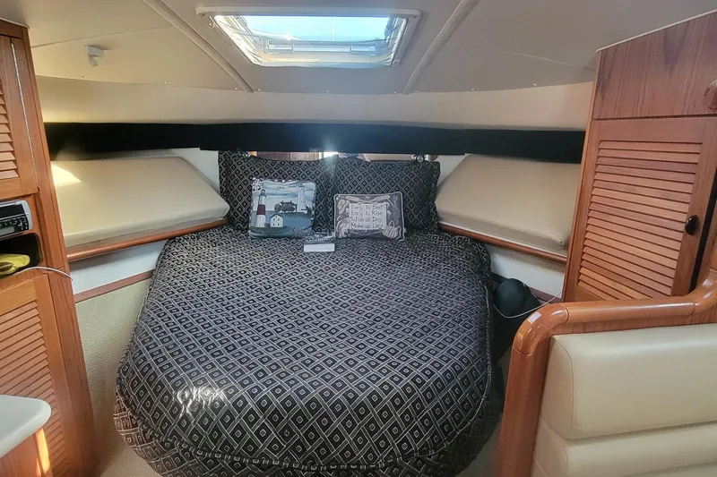 Valkyrie Yacht Photos Pics Luxurious cabin interior of a 2004 Pursuit 3400 Offshore boat with cozy bedding.