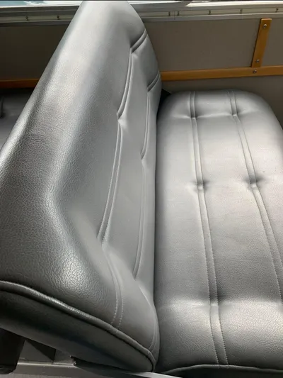  Yacht Photos Pics Gray leather seat in a 2005 Coastal Craft 32 boat interior.