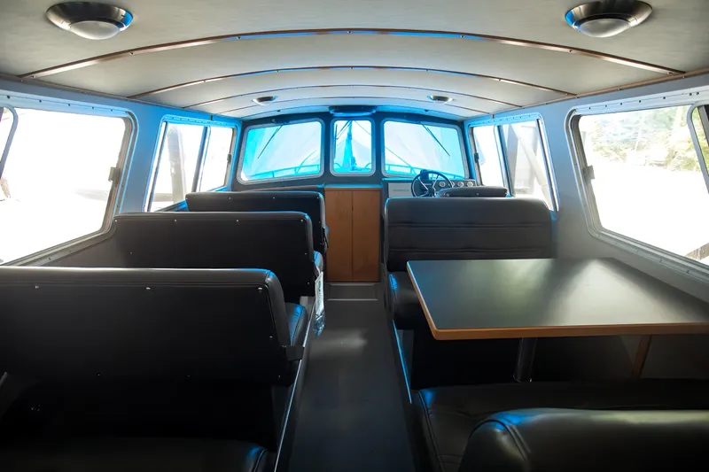  Yacht Photos Pics Interior of 2005 Coastal Craft 32 boat with seating and table.