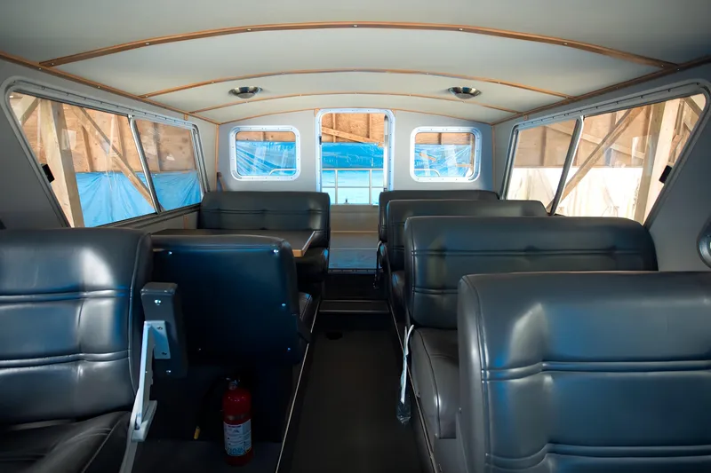  Yacht Photos Pics Interior of 2005 Coastal Craft 32 boat with leather seating and windows.