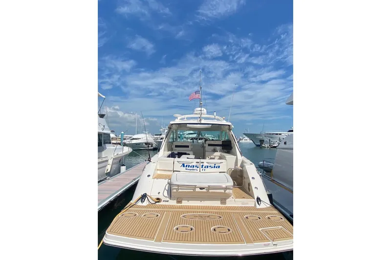  Yacht Photos Pics 2010 Sea Ray 450 Sundancer yacht docked at marina under clear blue sky.