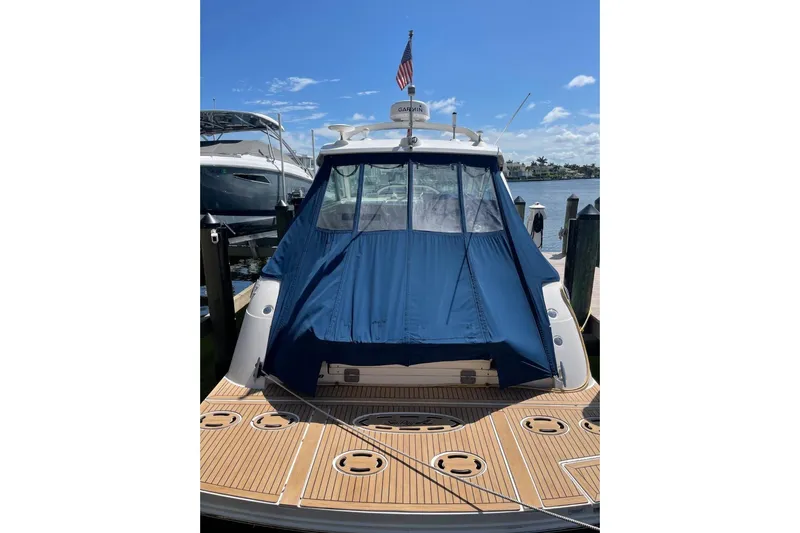  Yacht Photos Pics 2010 Sea Ray 450 Sundancer yacht docked with blue cover, sunny day.