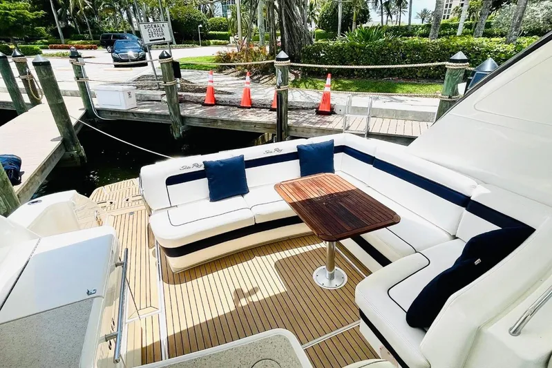  Yacht Photos Pics Luxurious 2010 Sea Ray 450 Sundancer yacht with elegant outdoor seating and wooden table.