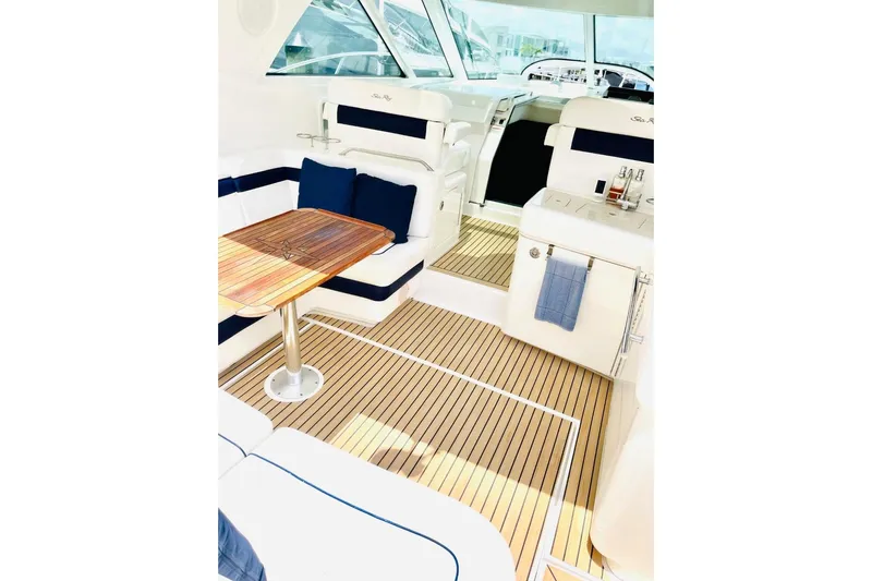  Yacht Photos Pics Luxurious interior of 2010 Sea Ray 450 Sundancer yacht with elegant seating and wooden table.