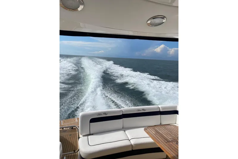  Yacht Photos Pics 2010 Sea Ray 450 Sundancer cruising, leaving a wake in the ocean.