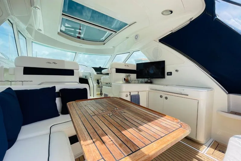  Yacht Photos Pics Luxurious interior of 2010 Sea Ray 450 Sundancer yacht with elegant seating and wooden table.