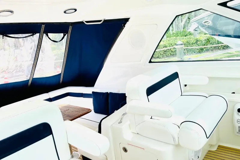  Yacht Photos Pics Luxurious interior of 2010 Sea Ray 450 Sundancer yacht with white seating and blue accents.