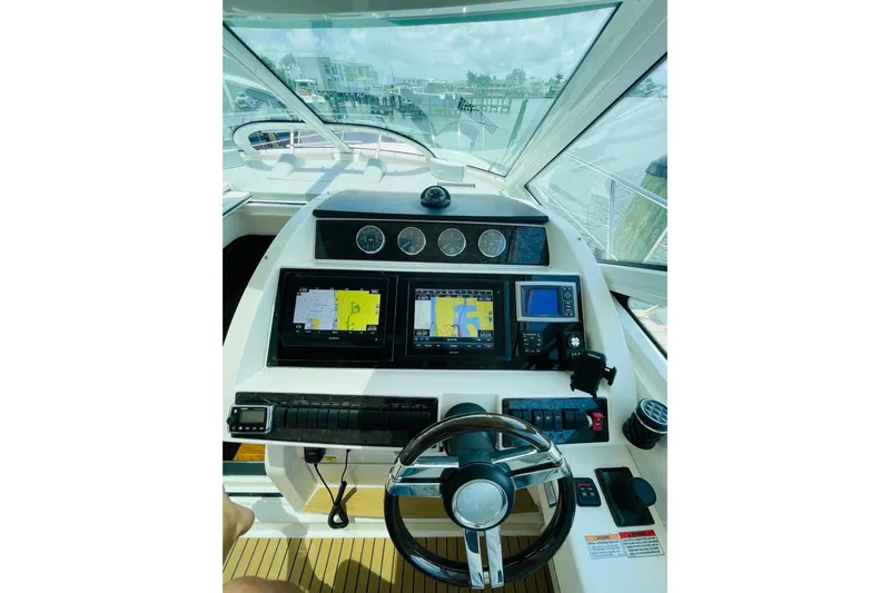  Yacht Photos Pics 2010 Sea Ray 450 Sundancer helm with navigation screens and steering wheel.
