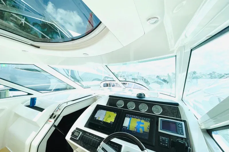  Yacht Photos Pics Helm of 2010 Sea Ray 450 Sundancer with navigation screens and panoramic windows.