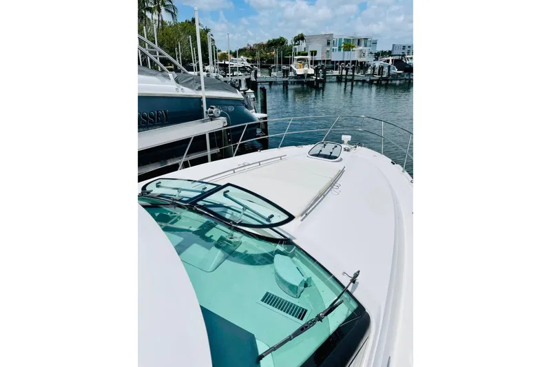  Yacht Photos Pics 2010 Sea Ray 450 Sundancer yacht docked at a marina, clear sky, and waterfront view.