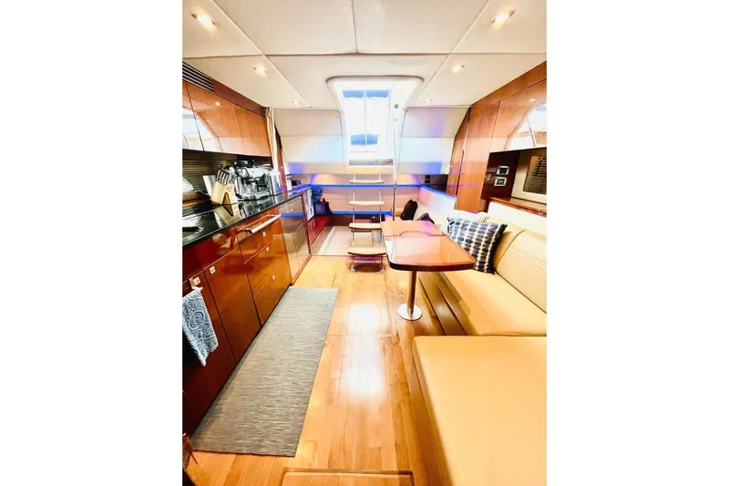  Yacht Photos Pics Luxurious interior of 2010 Sea Ray 450 Sundancer yacht with modern kitchen and seating area.