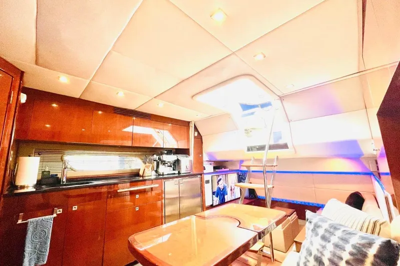  Yacht Photos Pics Luxurious interior of 2010 Sea Ray 450 Sundancer yacht with modern kitchen and seating area.