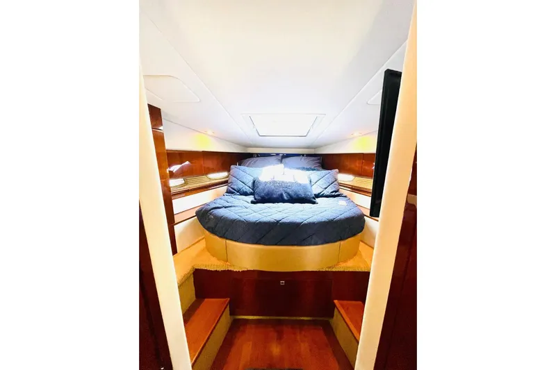  Yacht Photos Pics Luxurious cabin interior of 2010 Sea Ray 450 Sundancer yacht with cozy bedding.