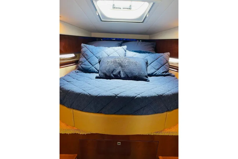  Yacht Photos Pics Luxurious cabin interior of 2010 Sea Ray 450 Sundancer yacht with cozy bedding.