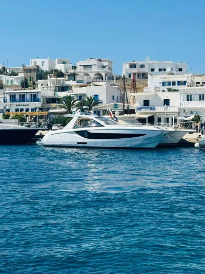  Yacht Photos Pics 2024 Azimut Verve 42 yacht docked in a scenic coastal town harbor.