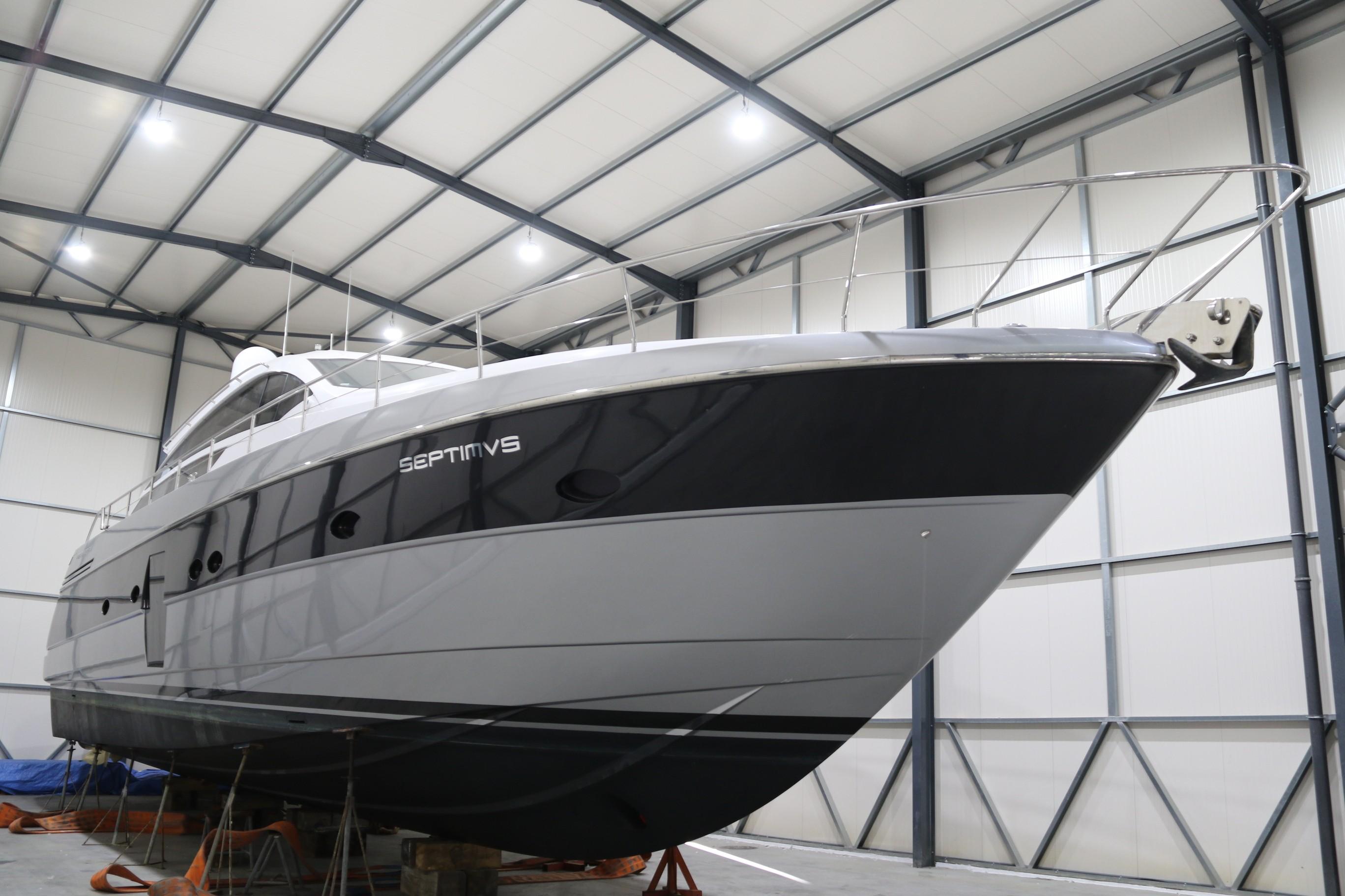 2010 Pershing 64 yacht in storage, sleek design, indoor facility.