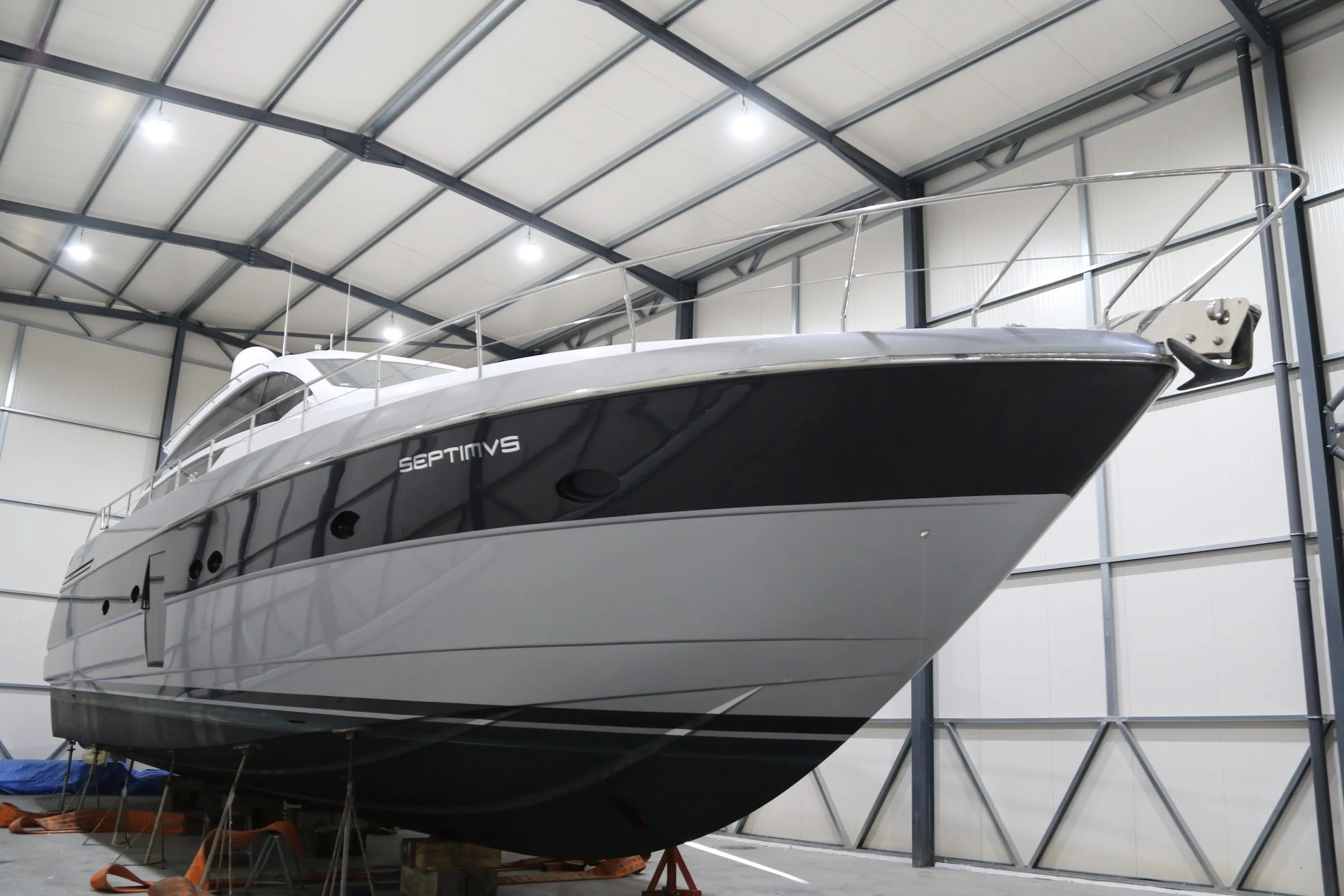 2010 Pershing 64 yacht in storage, sleek design, indoor facility.