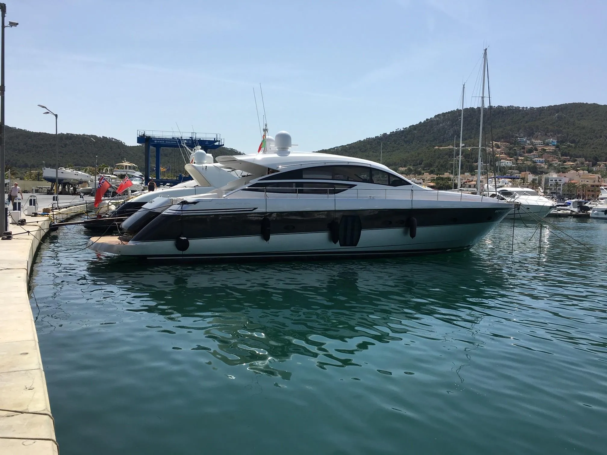 2010 Pershing 64 yacht docked in a serene marina setting.