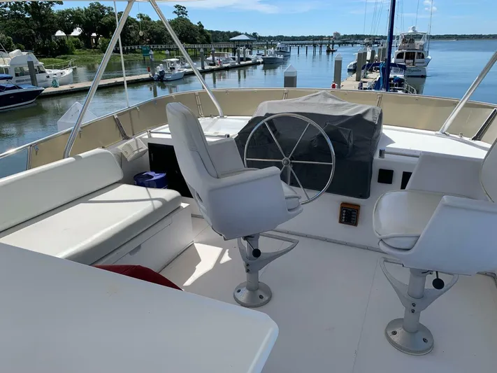 Sundog Yacht Photos Pics 1996 Ocean Alexander 423 Classico flybridge with helm, seating, and marina view.