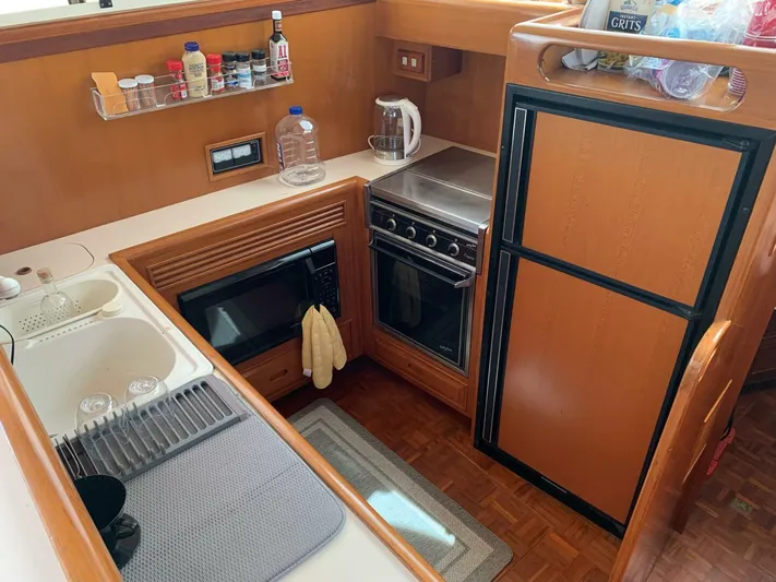 Sundog Yacht Photos Pics 1996 Ocean Alexander 423 Classico yacht kitchen with stove, microwave, sink, and refrigerator.