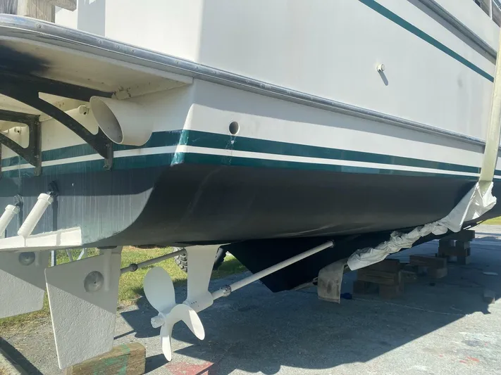 Sundog Yacht Photos Pics 1996 Ocean Alexander 423 Classico boat hull and propeller on dry dock.