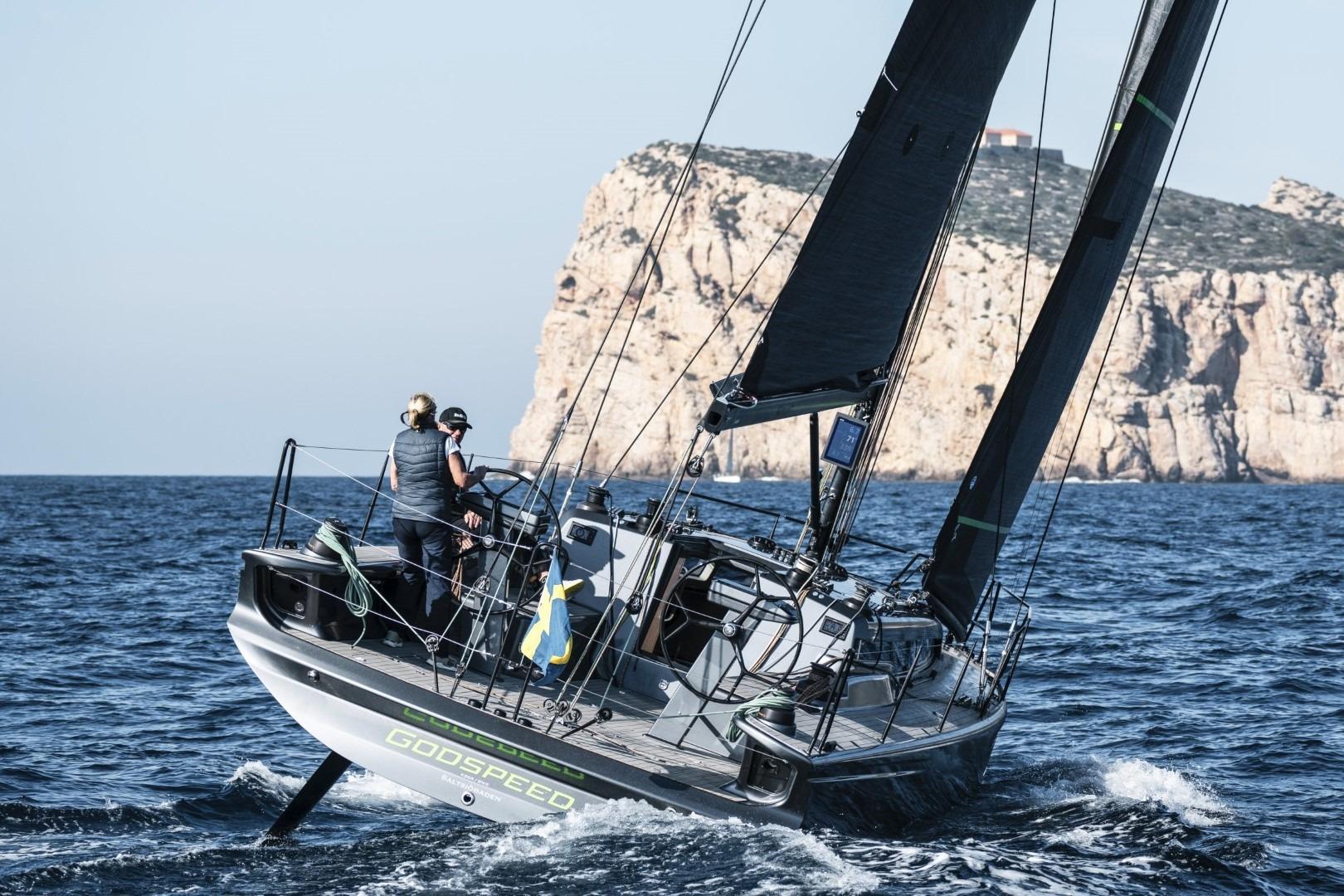 Sailing yacht Shogun 43 navigating near rocky coastline, 2023 model.