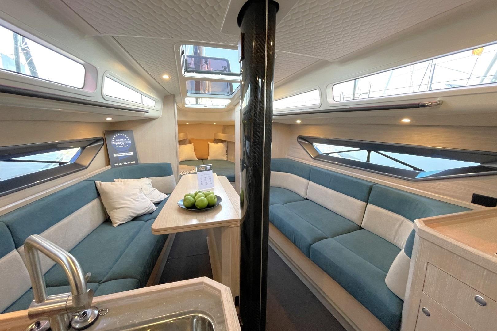 Luxurious interior of 2023 Shogun 43 yacht with modern seating and skylight.