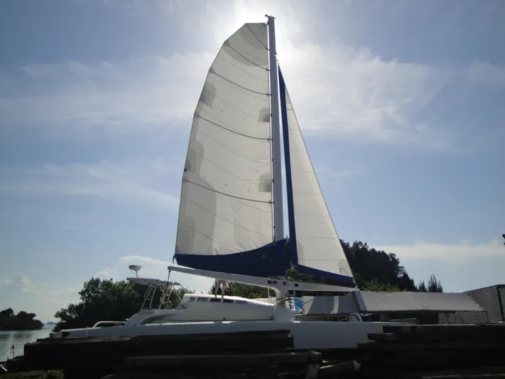 Panta Rhei Yacht Photos Pics Sailing catamaran Roake 50, 2012 model, with sails unfurled against a sunny sky.