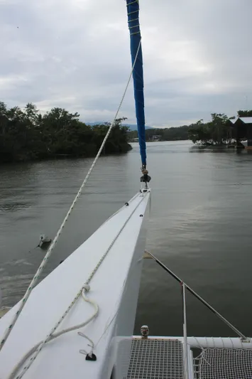 Panta Rhei Yacht Photos Pics Sailboat on calm river, Custom Roake 50, 2012 model, overcast sky.