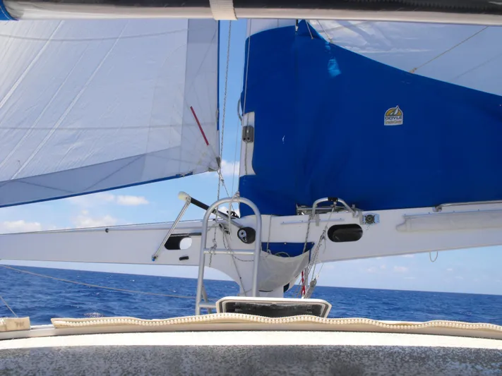 Panta Rhei Yacht Photos Pics Sailing on a 2012 Custom Roake 50 yacht with blue sails over open ocean.