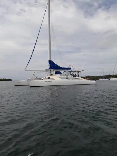 Panta Rhei Yacht Photos Pics Custom Roake 50 catamaran from 2012 on calm waters under cloudy skies.