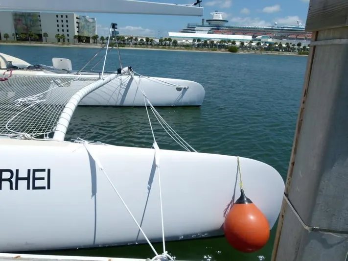 Panta Rhei Yacht Photos Pics Custom Roake 50 catamaran docked with buoy, 2012 model, in a sunny marina.