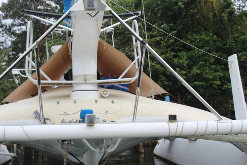 Panta Rhei Yacht Photos Pics Custom Roake 50 sailboat, 2012 model, docked with lush greenery in the background.