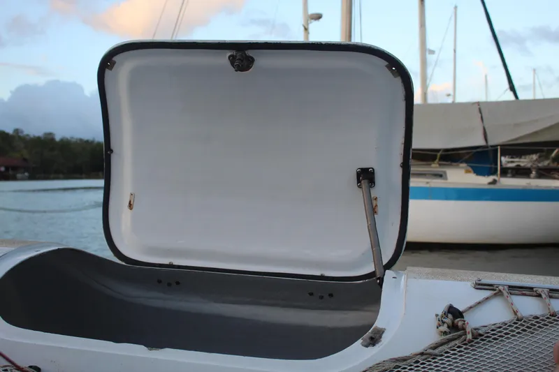 Panta Rhei Yacht Photos Pics Open storage compartment on 2012 Custom Roake 50 boat, docked near sailboats.