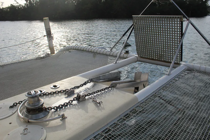 Panta Rhei Yacht Photos Pics Custom Roake 50 catamaran deck with winch and netting, 2012 model, on calm water.
