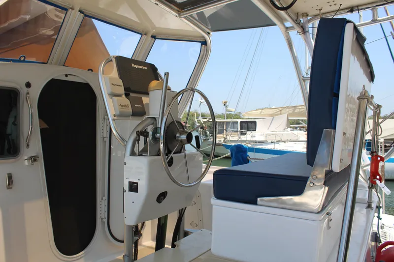 Panta Rhei Yacht Photos Pics Interior view of 2012 Custom Roake 50 yacht cockpit with steering wheel and seating.