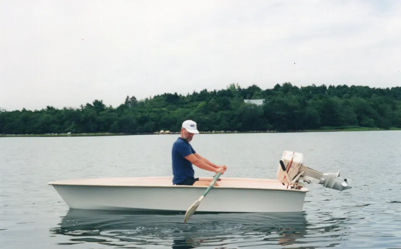 Panta Rhei Yacht Photos Pics Man rowing a Custom Roake 50 boat on a calm lake, 2012.