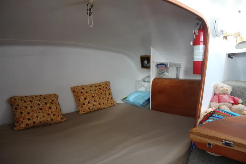 Panta Rhei Yacht Photos Pics Cozy cabin interior of 2012 Custom Roake 50 boat with bed, pillows, and teddy bear.