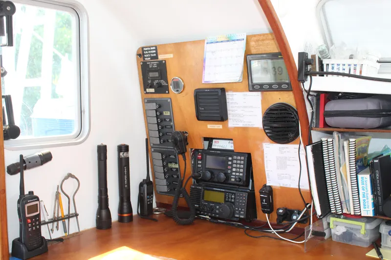 Panta Rhei Yacht Photos Pics Boat navigation station with communication equipment, flashlights, and organized manuals on a Custom Roake 50, 2012.