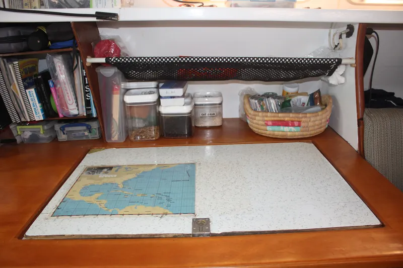 Panta Rhei Yacht Photos Pics Nautical navigation station with map, storage, and supplies on a 2012 Custom Roake 50 boat.